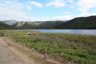 Scenic view of land and mountains against sky