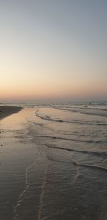 Scenic view of beach against sky during sunset