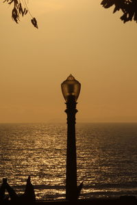 Silhouette of street light on sea