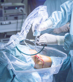 Midsection of surgeon operating patient at hospital