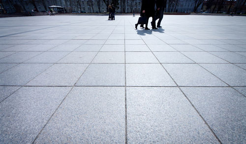 Low section of man walking on zebra crossing