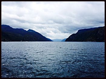 Scenic view of mountains against cloudy sky