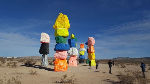 Rear view of people walking in desert