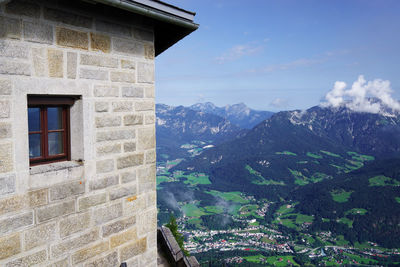 House by mountains against sky