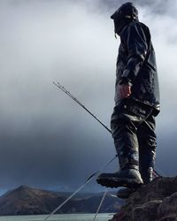 Low angle view of a man against clouds