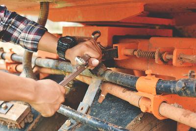 Midsection of man working using tool