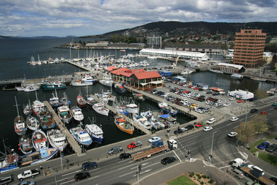 High angle view of boats moored at harbor in city