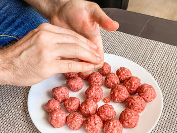 Midsection of man holding strawberries