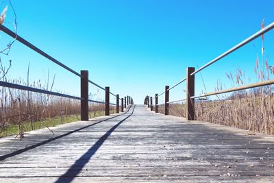 Metal walkway against clear blue sky