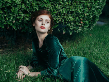 Portrait of young woman sitting outdoors