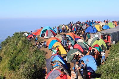 High angle view of people and tents on mountain peak