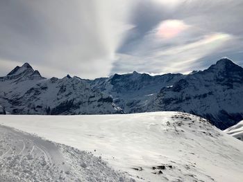 Scenic view of snowcapped mountains against sky