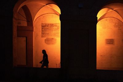 Silhouette people standing in tunnel