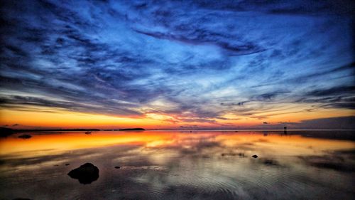 Scenic view of sea against romantic sky at sunset