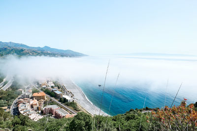 Sicily. ionian sea cost line view from top on santa teresa di riva covered by fog. beauty in sicily 