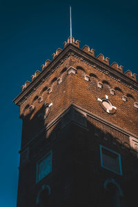 Low angle view of building against clear blue sky