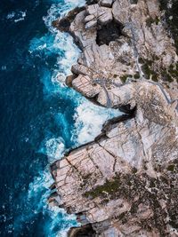 High angle view of rock formation by sea