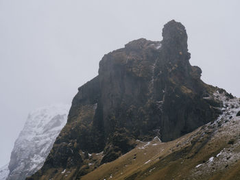 Rock formations on mountain against clear sky