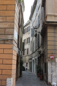 Narrow street amidst buildings in city