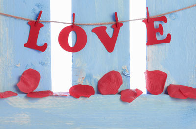Close-up of love text hanging on wall