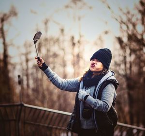 Woman taking selfie standing outdoors