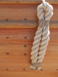 Close-up of rope tied on wood