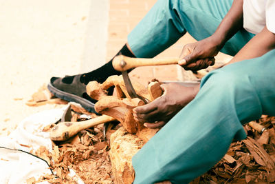 Low section of men working on wood