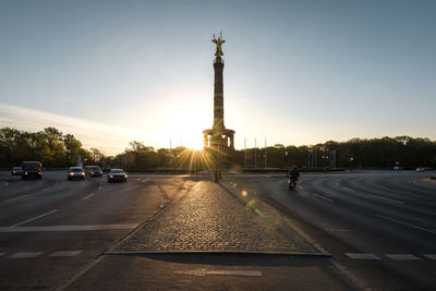 Victory column by road against sky during sunset