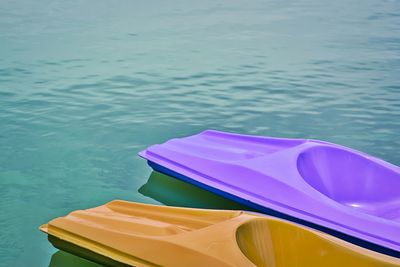 Close-up of multi colored boat moored in lake