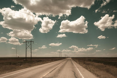 Country road against sky