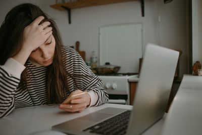 Woman watching on mobile screen with unhappy face reading news 