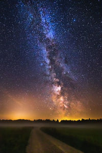 Scenic view of field against sky at night