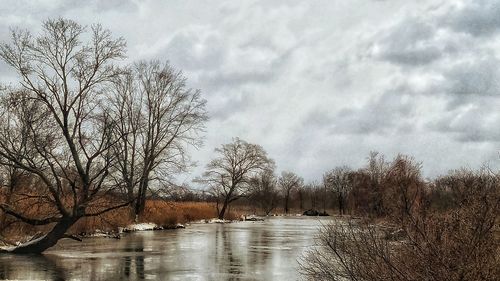 Scenic view of river against sky during winter