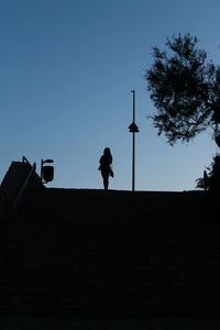 Low angle view of silhouette man against clear sky