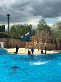 People in swimming pool against sky