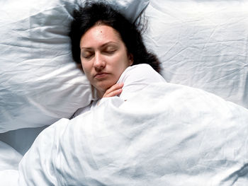 Young woman sleeping on bed