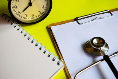 High angle view of clock on table