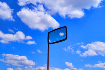 Low angle view of mirror against sky