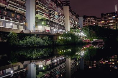 Illuminated city against sky at night