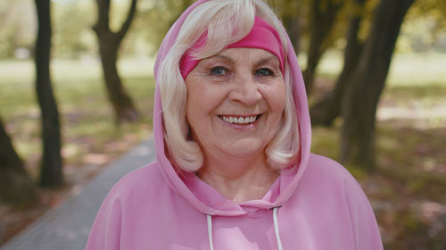 Portrait of senior woman in hooded shirt