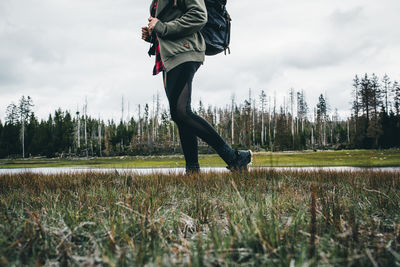 Low section of hiking person against sky.