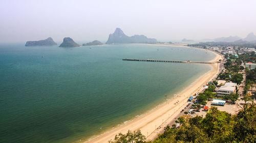 High angle view of sea and city against sky