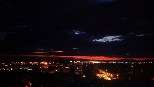 High angle view of city lit up at night