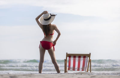 Full length of child on beach against sky