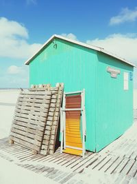 Hut at beach against sky