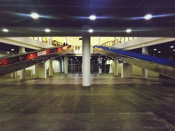 Illuminated underground walkway at night