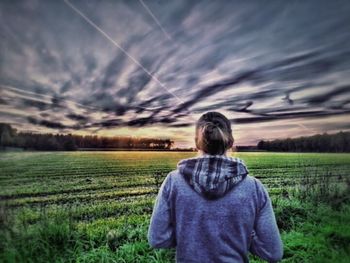 Scenic view of grassy field against sky