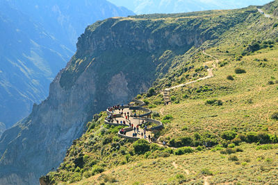 Visitors watching the andean condors from the viewing balcony of colca canyon, arequipa, peru