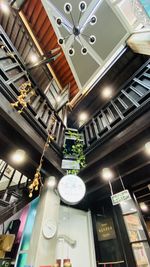 Low angle view of illuminated pendant lights hanging in building