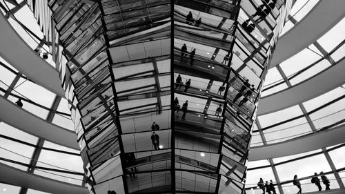 Reflection of people on glass in sir norman foster building